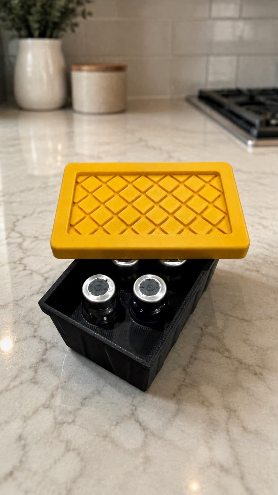 Black 3D-printed five-vial tote with a yellow textured lid